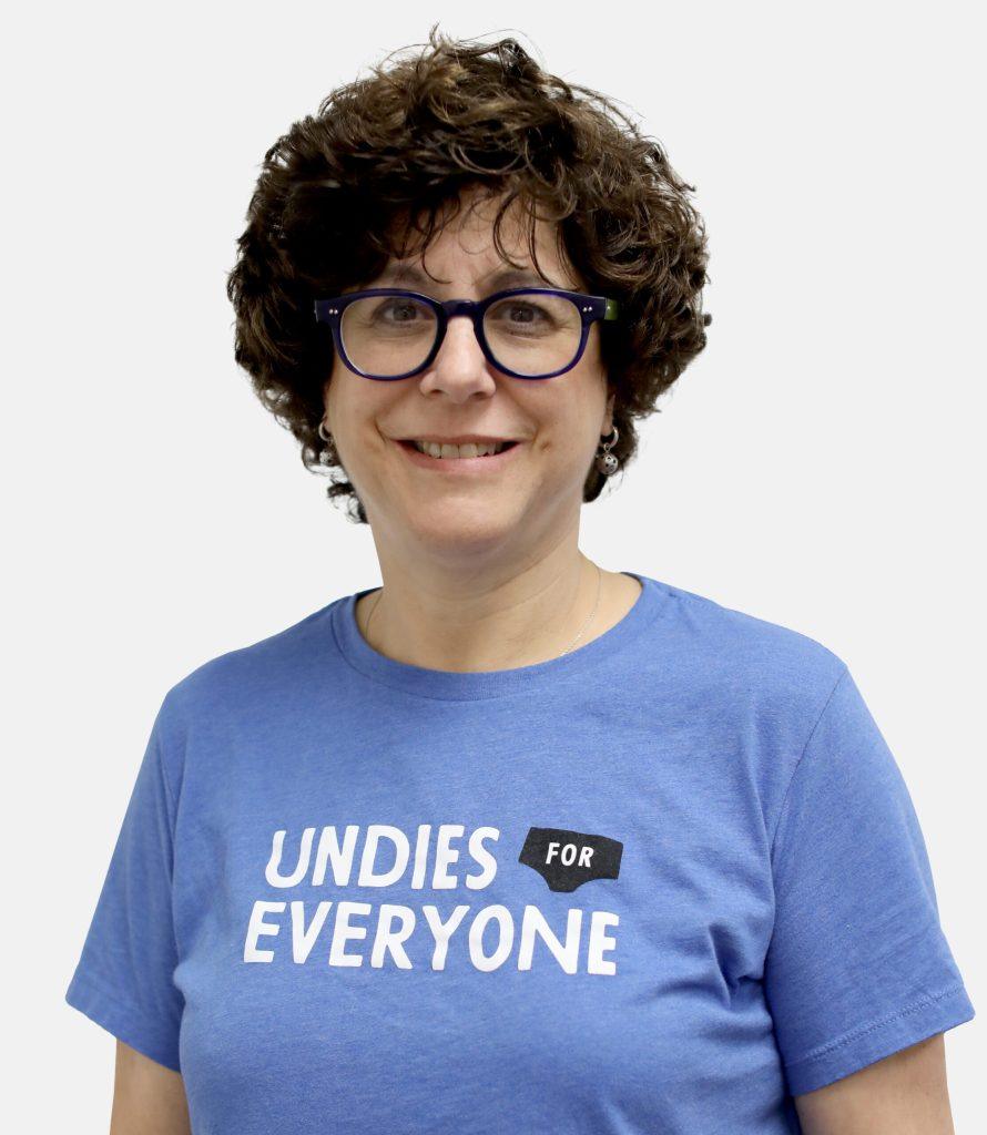 Woman in blue "Undies for Everyone" shirt