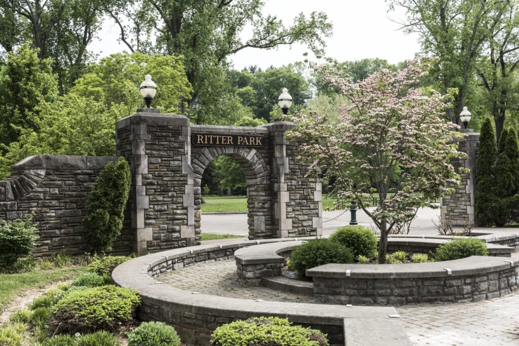 Stone entrance arch with Ritter Park sign and surrounding greenery.