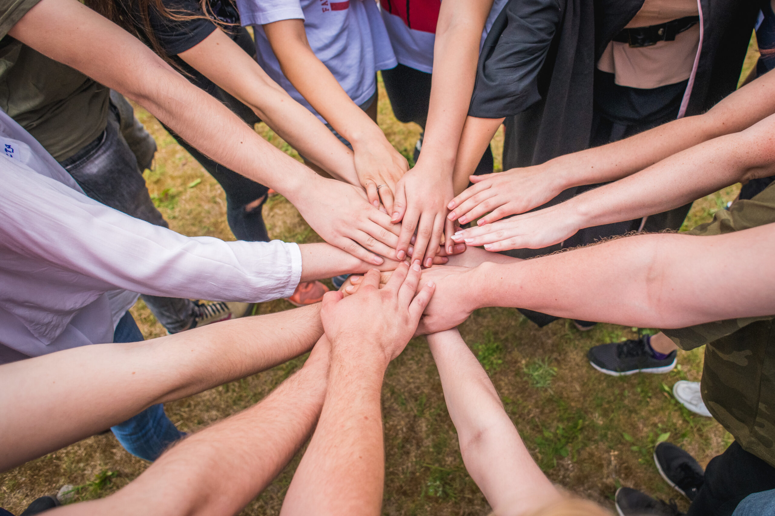 Group hands joined in unity.