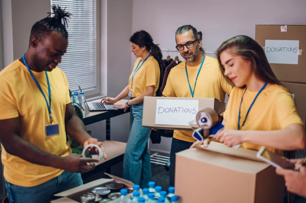 Group of multiracial volunteers working in community charity donation center